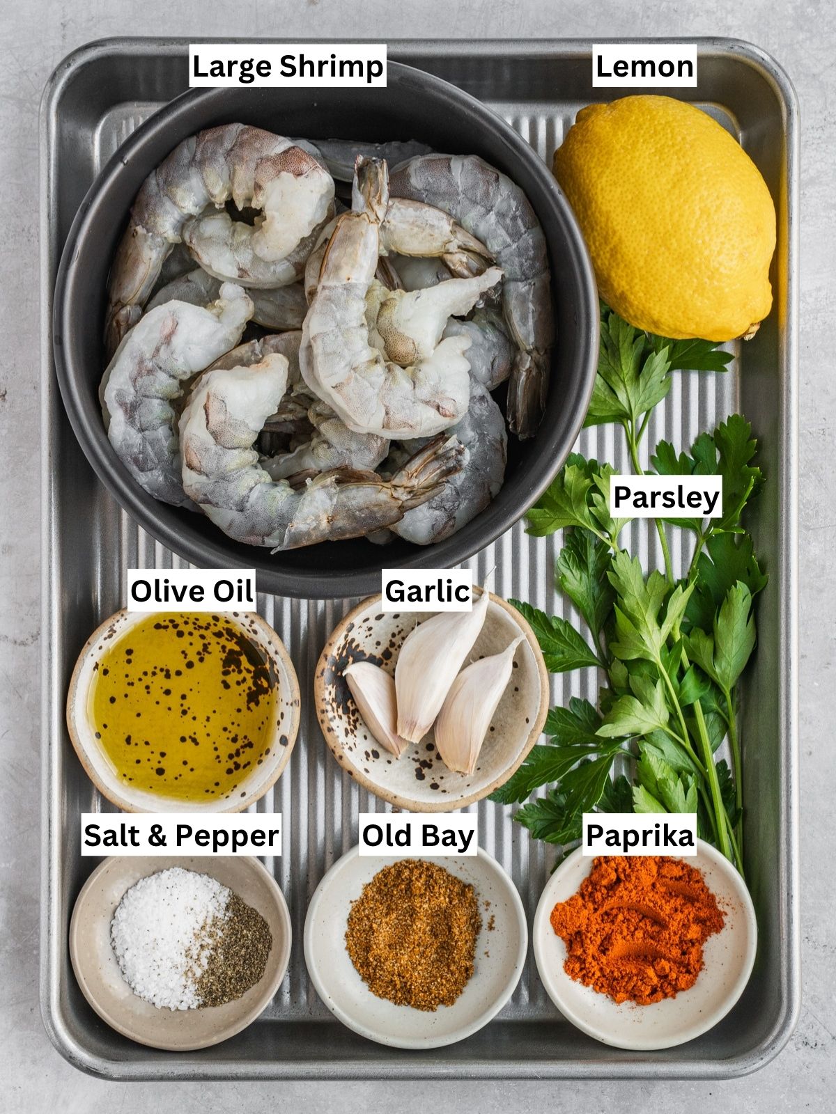 Grilled shrimp skewers recipe ingredients with individual labels on a metal tray.