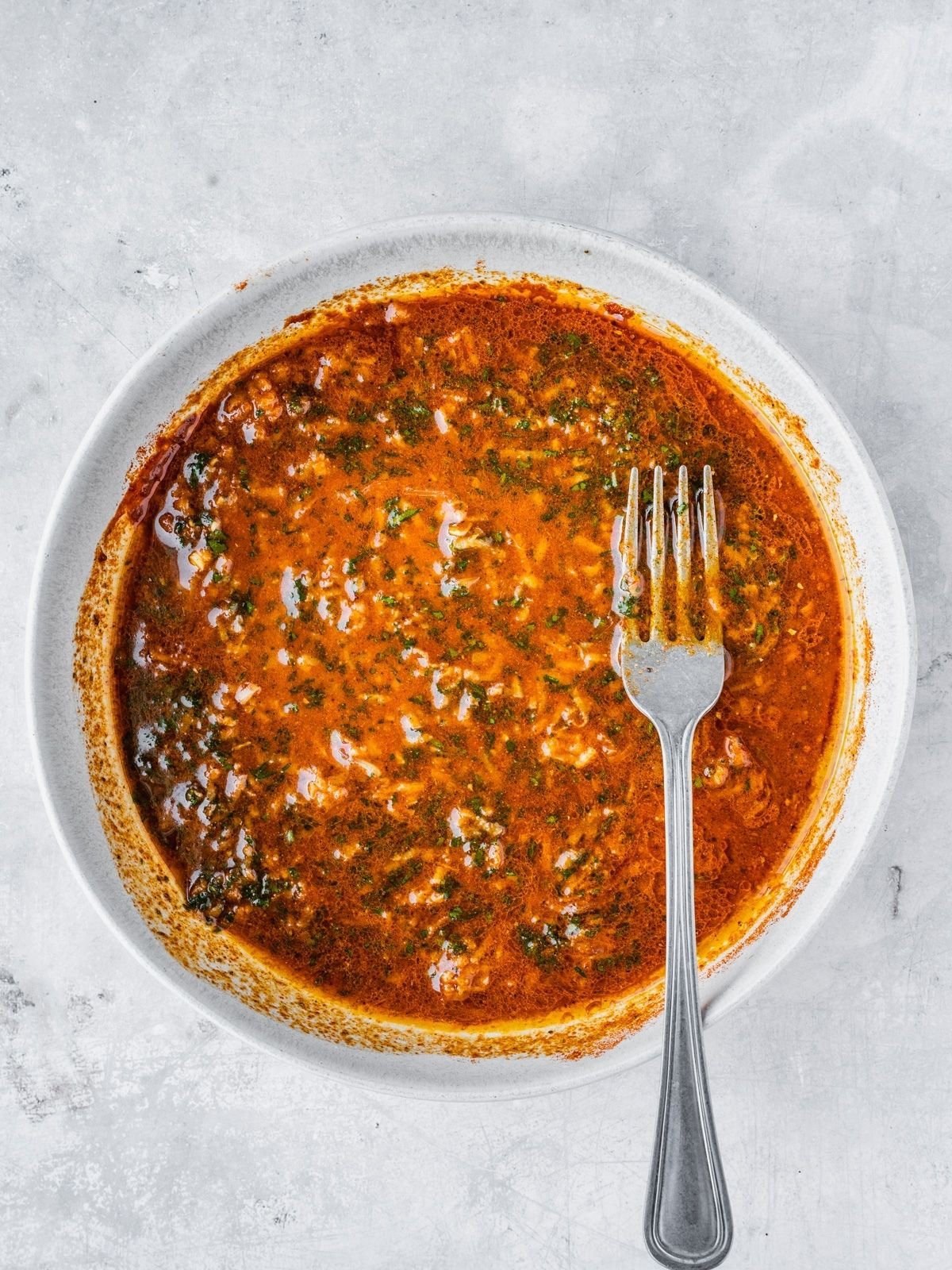 Bowl with lemon, olive oil and spice marinade.