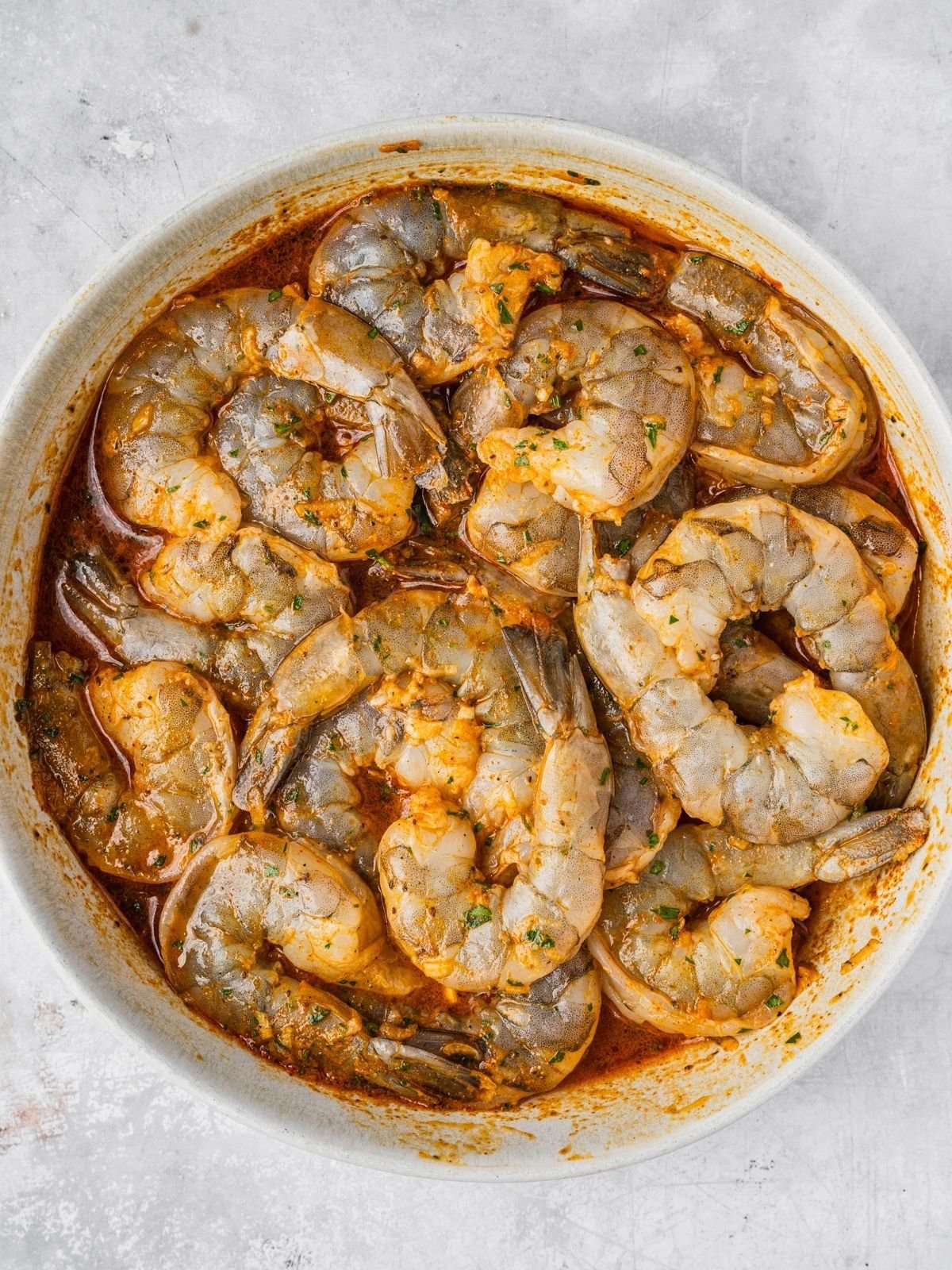 Shrimp marinating in a bowl.