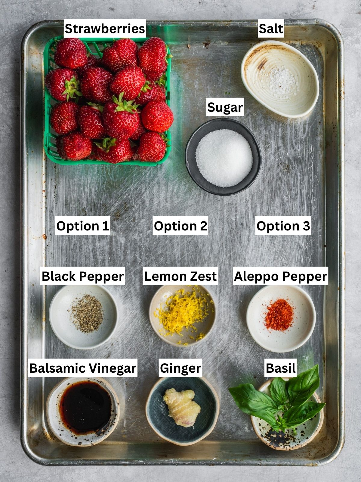 Macerated Strawberries recipe ingredients with individual labels on a metal tray.
