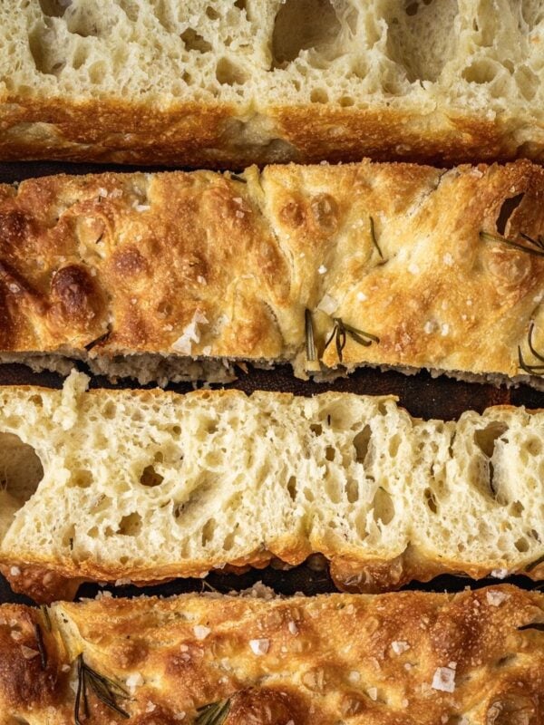 Same Day Focaccia sliced and laid out on a wooden cutting board.