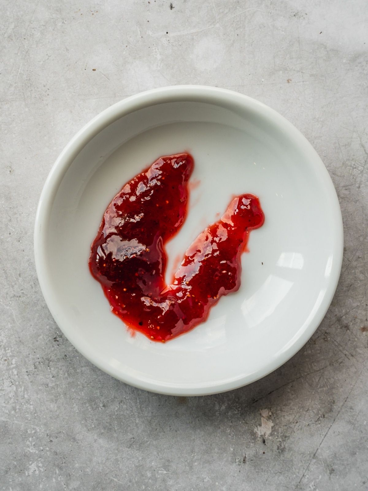 Testing the jam on a small cold plate by seeing if it forms a skin.
