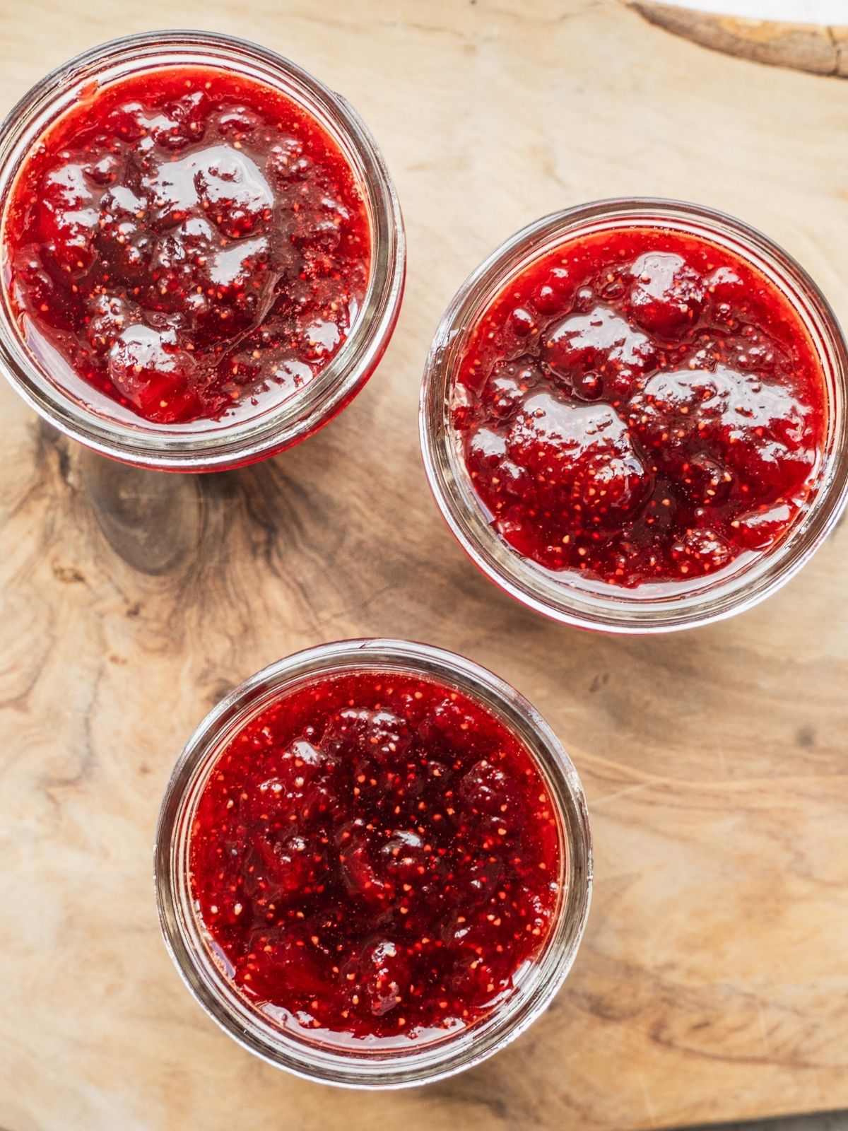 3 mason jars filled with strawberry balsamic vinegar jam.