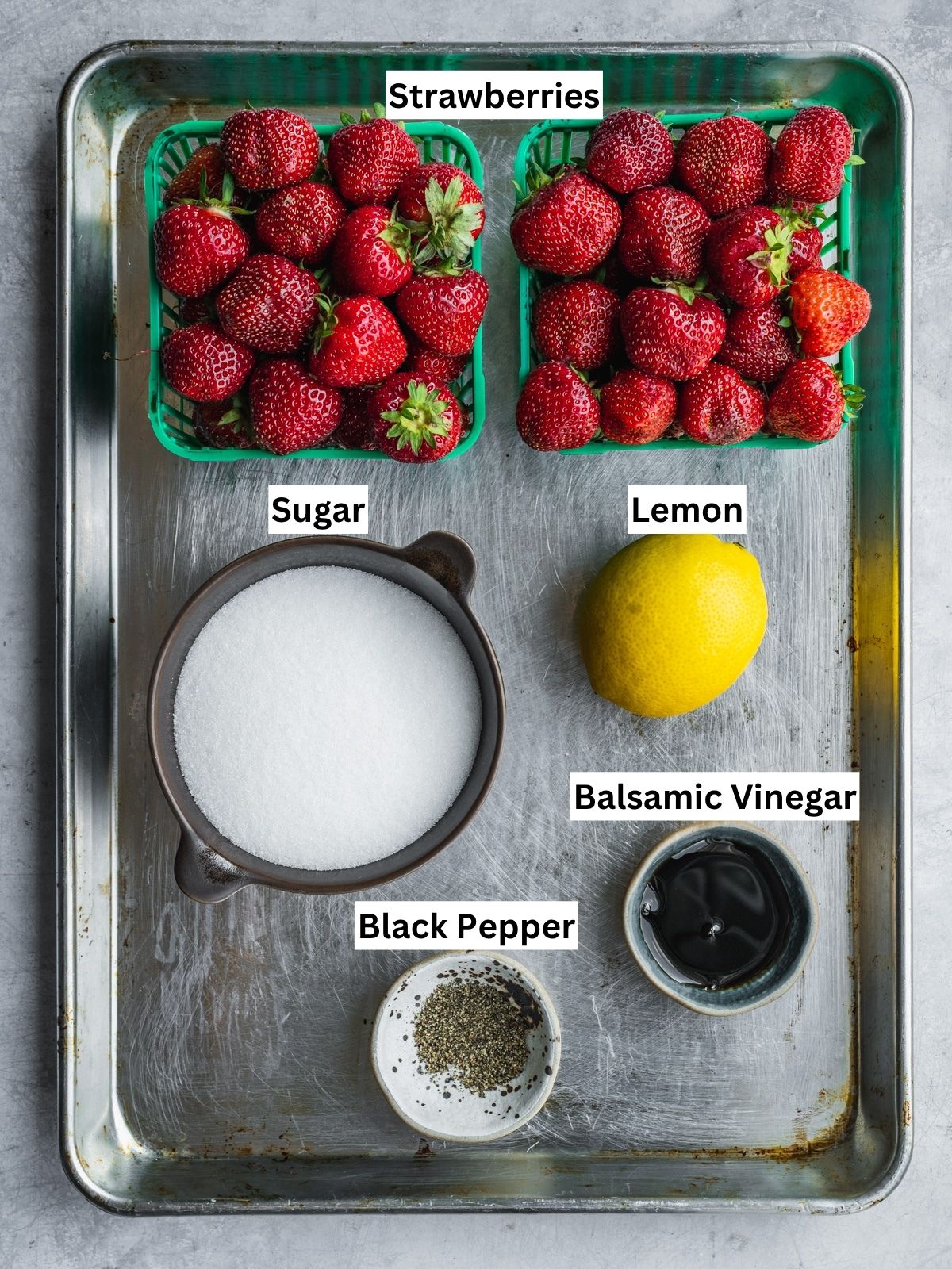Strawberry Balsamic Black Pepper Jam Recipe ingredients with individual labels on a metal tray.