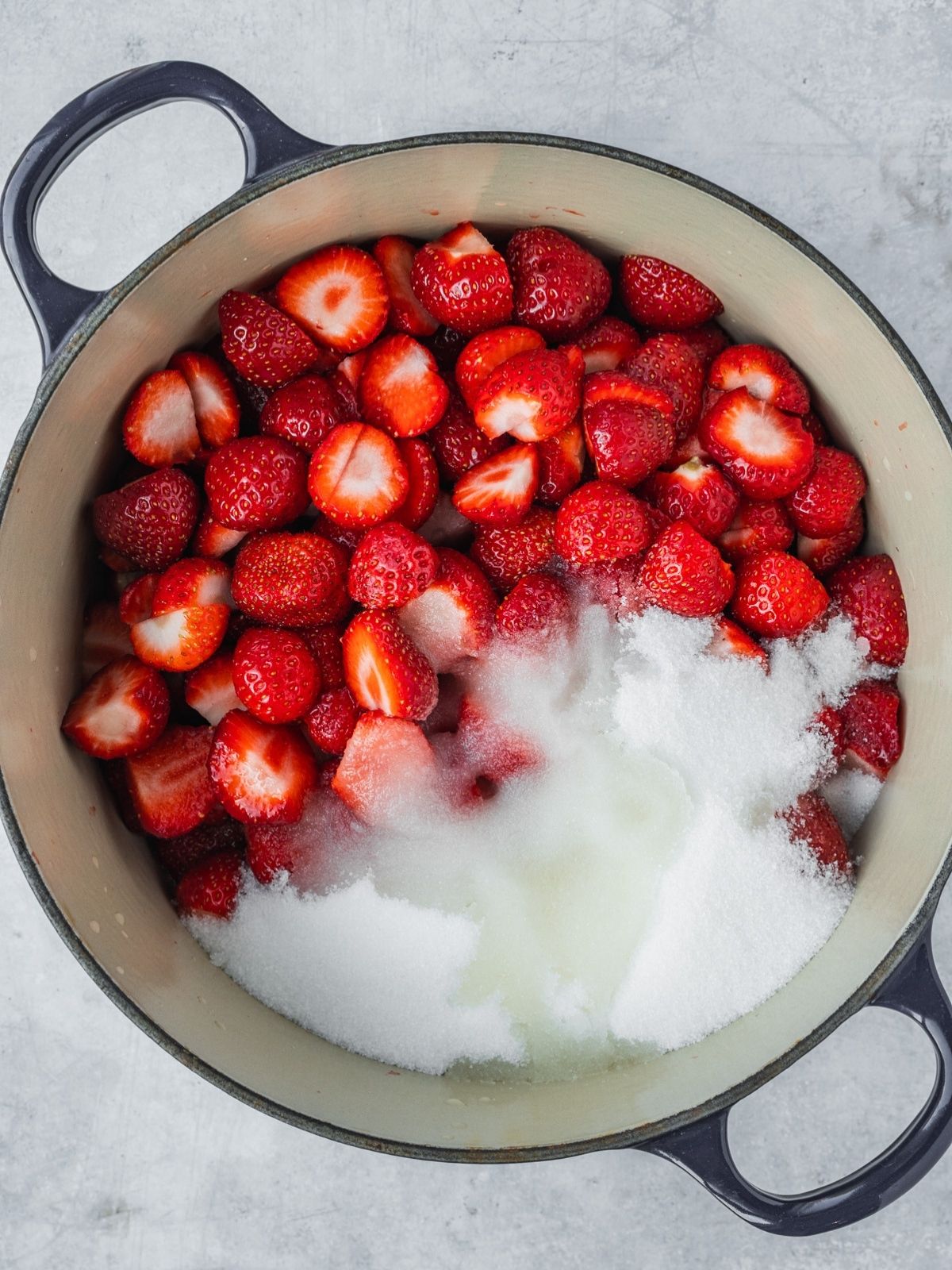 Chopped strawberries, sugar and lemon juice in a pot.