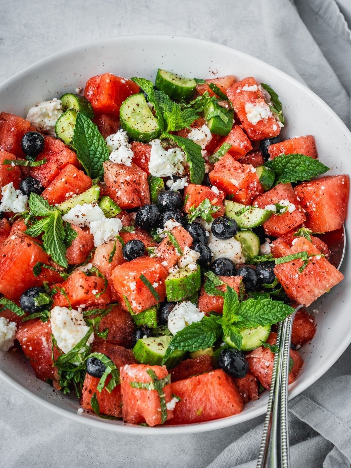 Watermelon blueberry feta salad with fresh mint in a serving bowl.