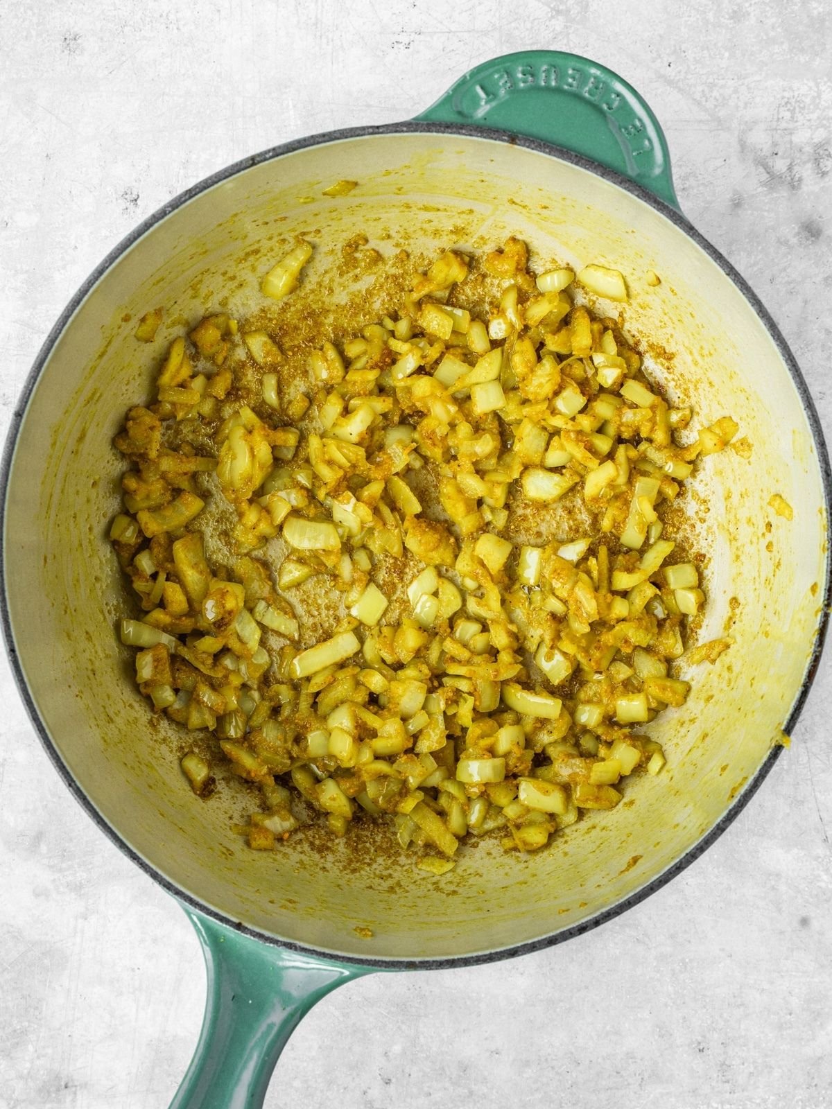 A pot with fried onions and spices.