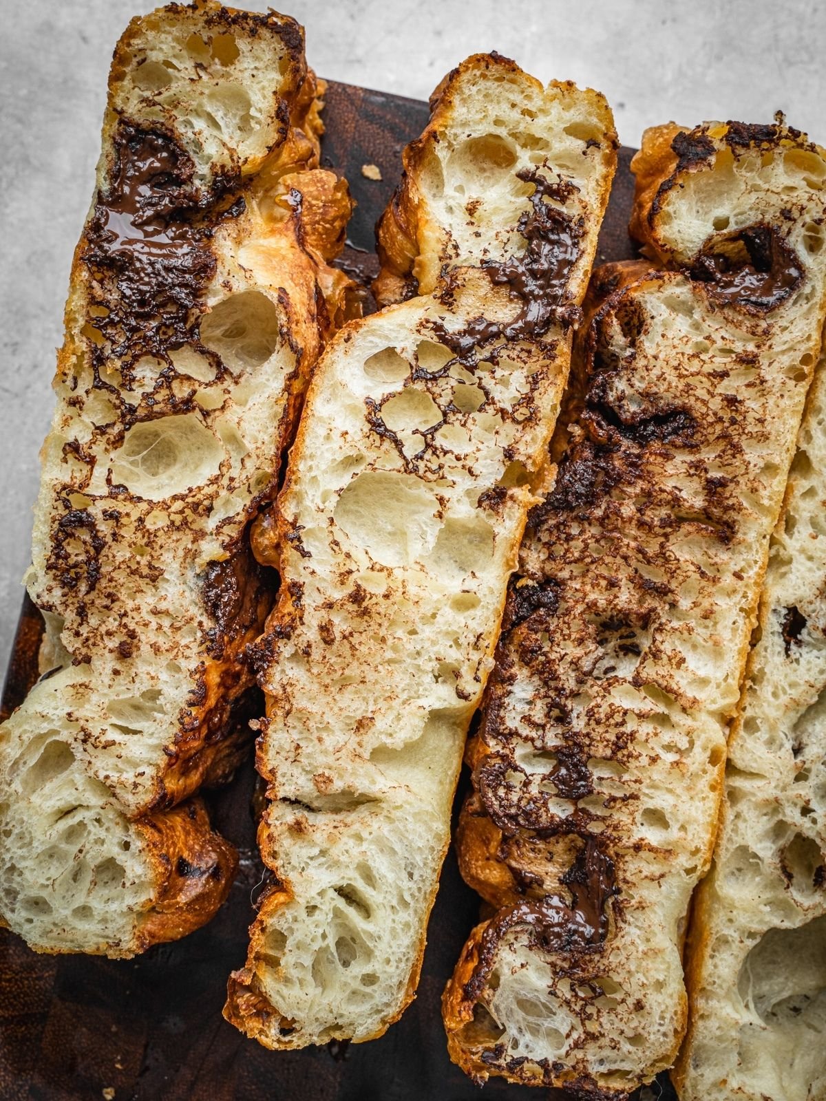 Chocolate Focaccia slices on a wooden cutting board.