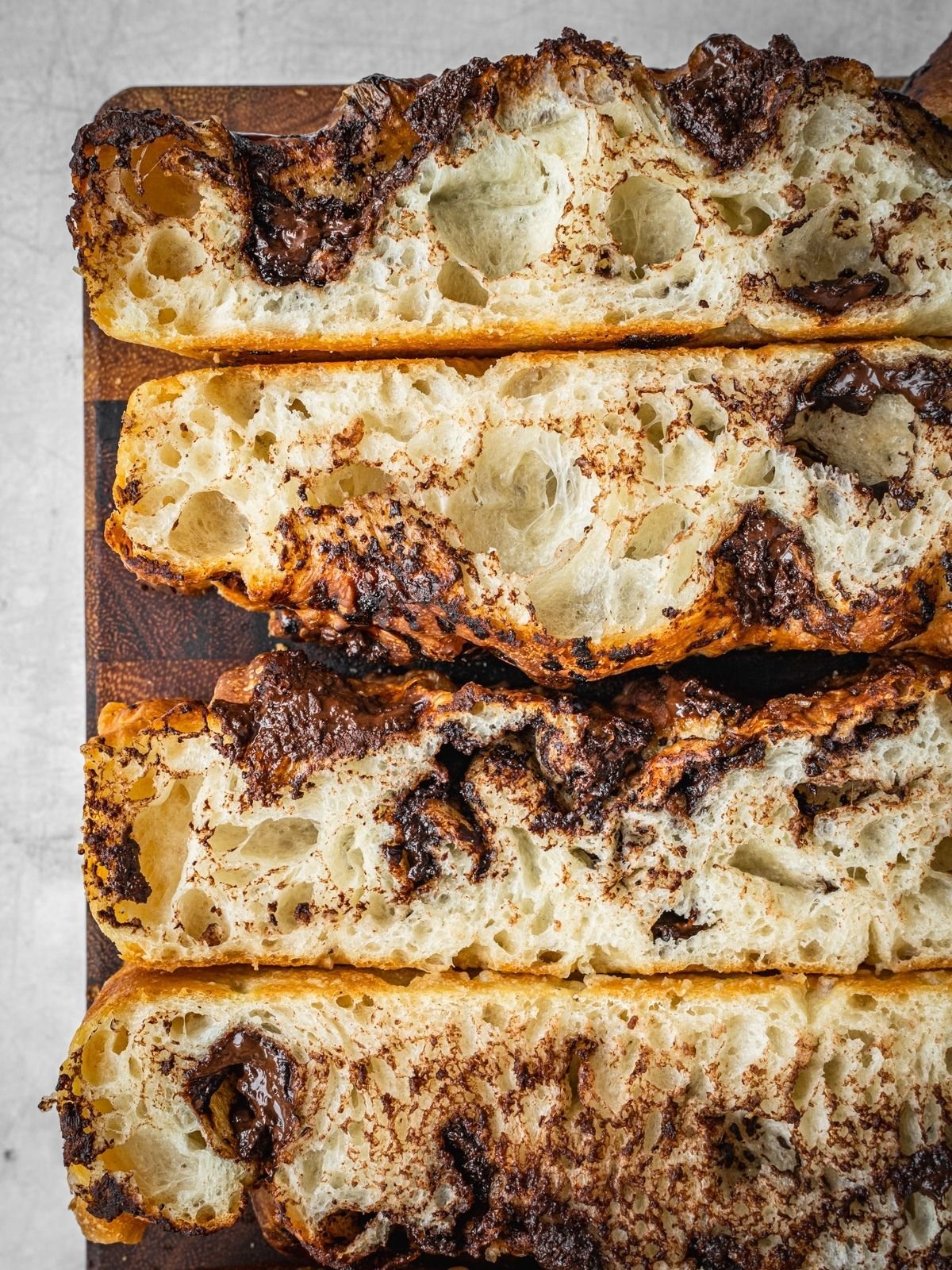 Chocolate Focaccia slices on a wooden cutting board.
