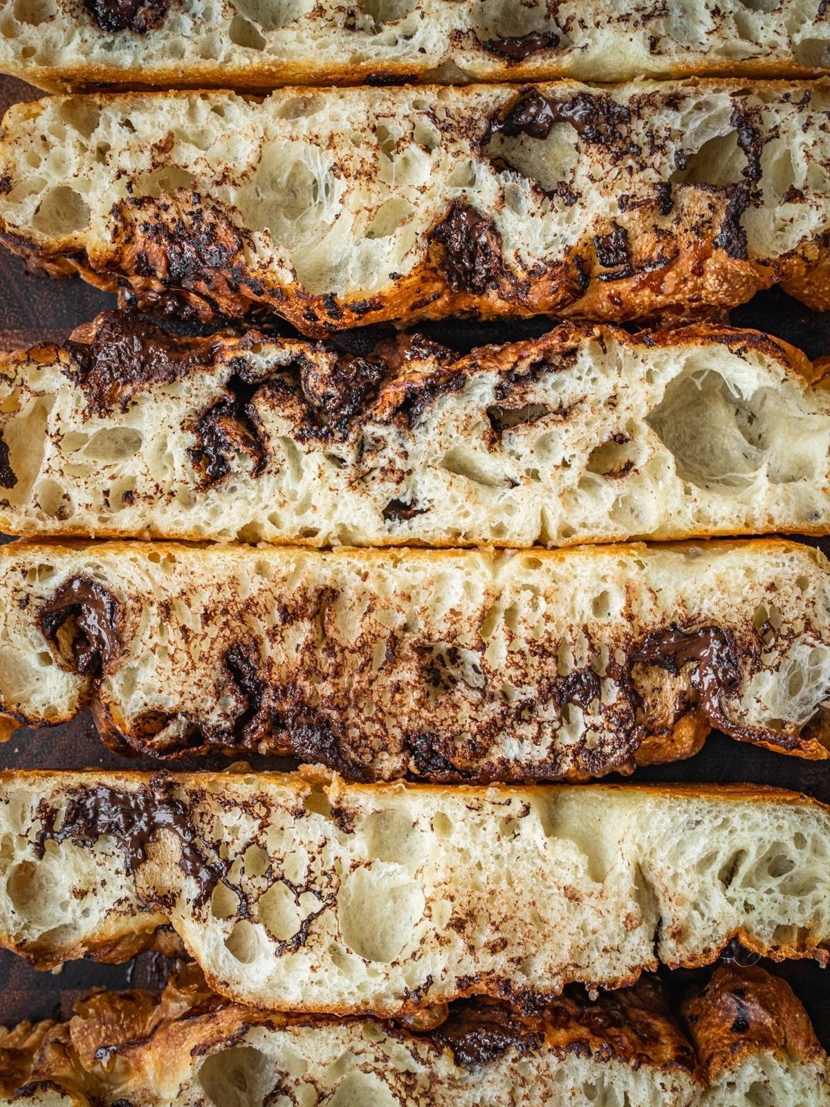 Chocolate Focaccia slices on a wooden cutting board.