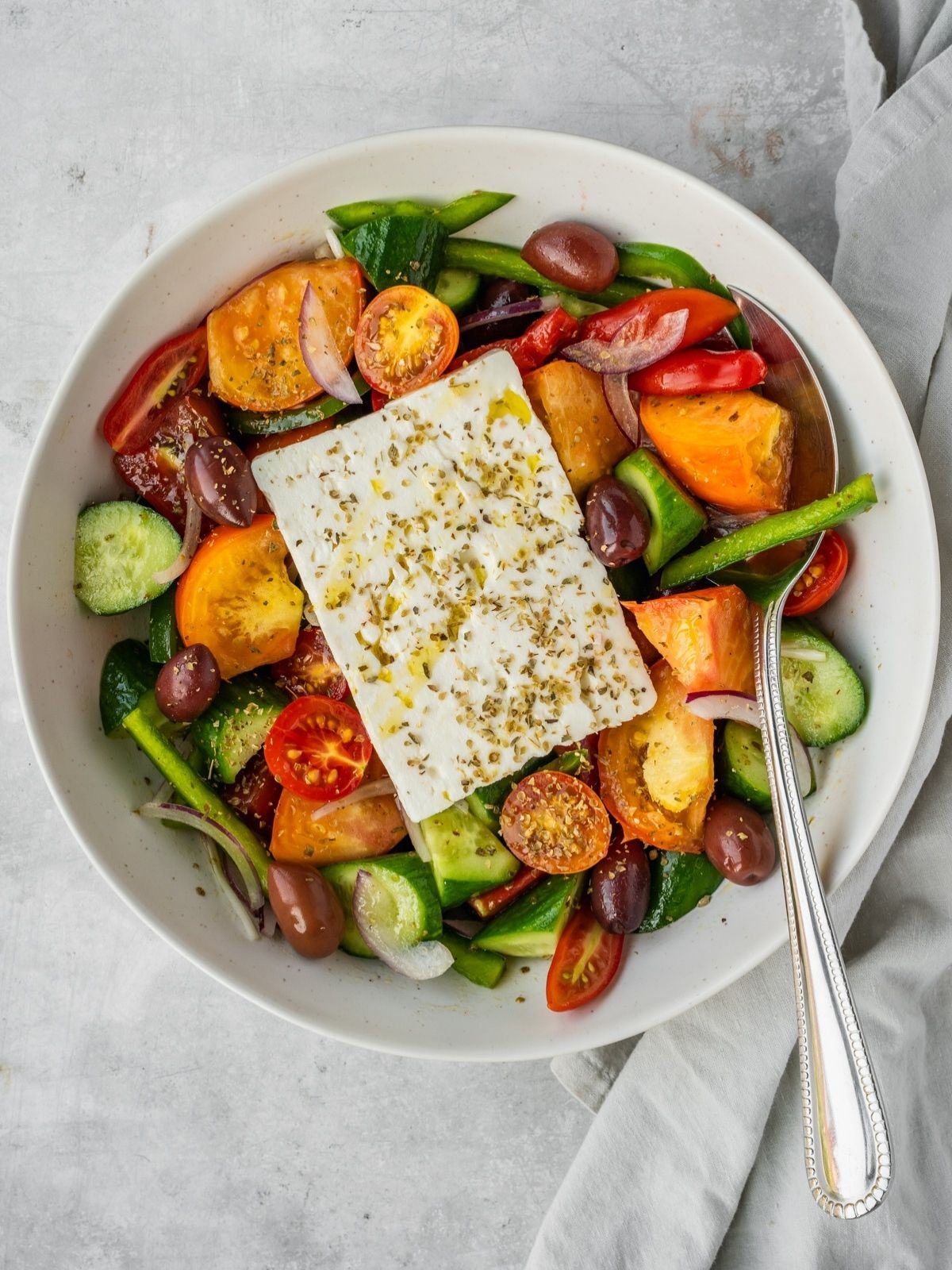 Hortiaki Greek Salad with fresh tomatoes, bell peppers, cucumbers, red onions, feta and oregano.
