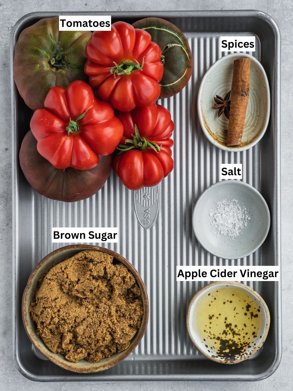 Tomato Jam recipe ingredients with individual labels on a metal tray.