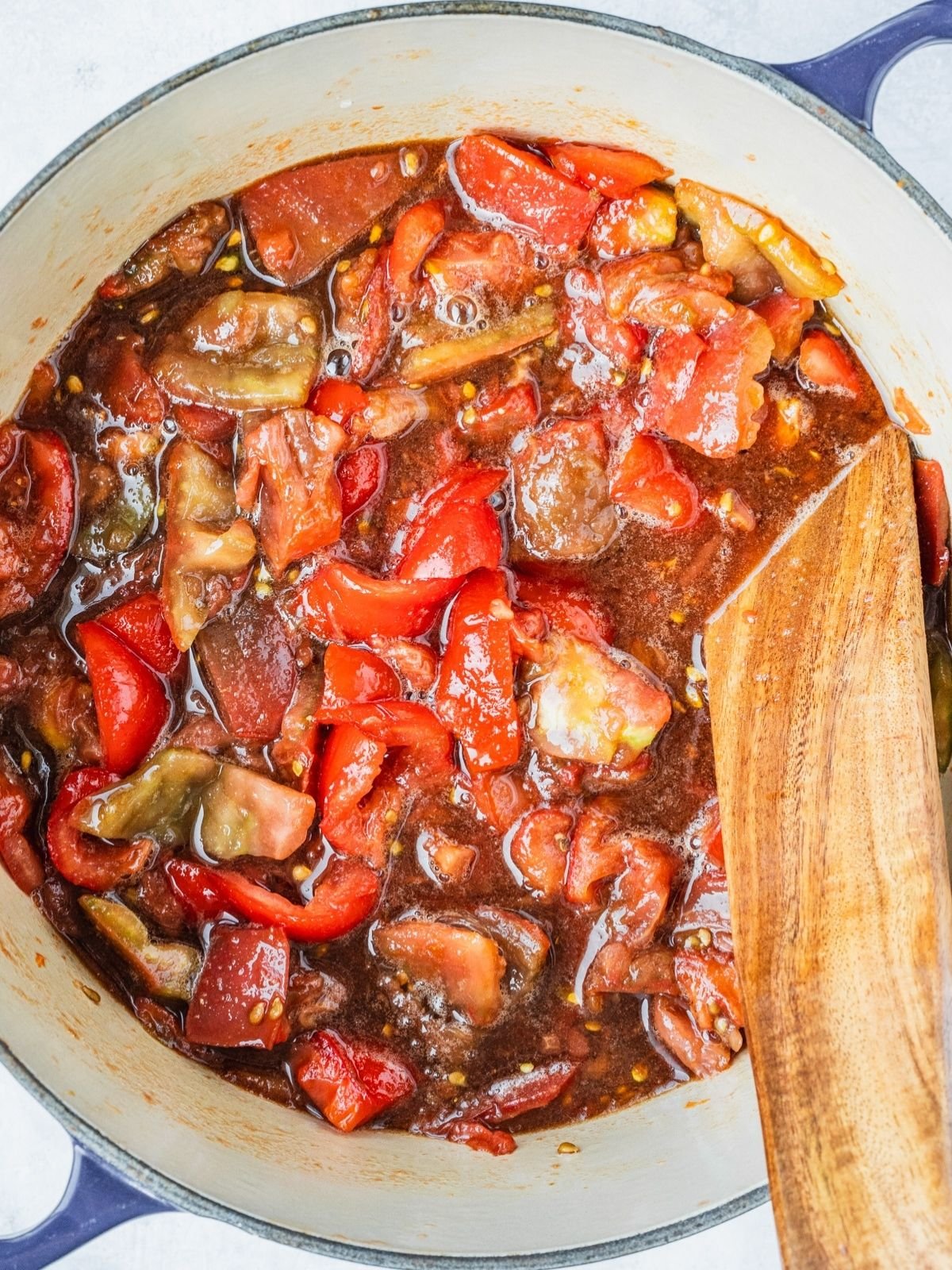 Pot with chunks of tomatoes, sugar, spices and vinegar right after first boil.