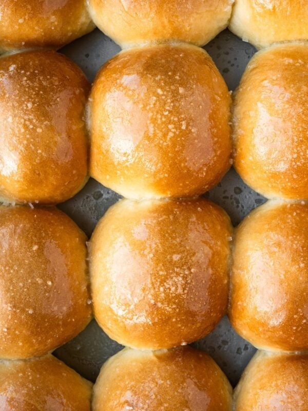 Buttery homemade dinner rolls in a baking tray.