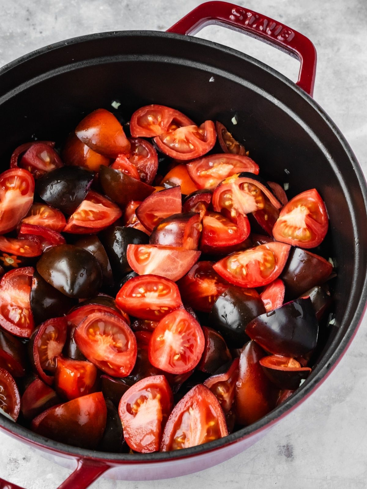Chunks of Midnight Roma tomatoes added to the pot.