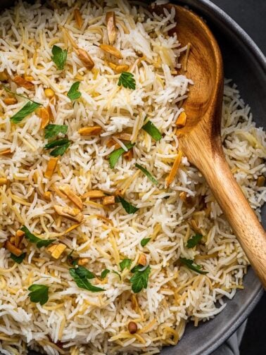 Bowl with vermicelli and rice garnished with nuts and parsley.