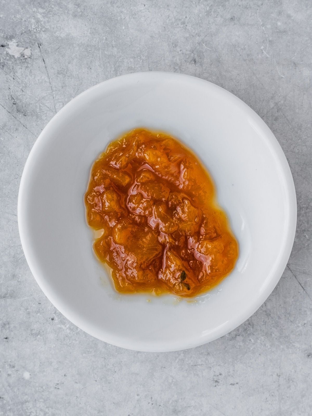 A small amount of jam on a cold plate.