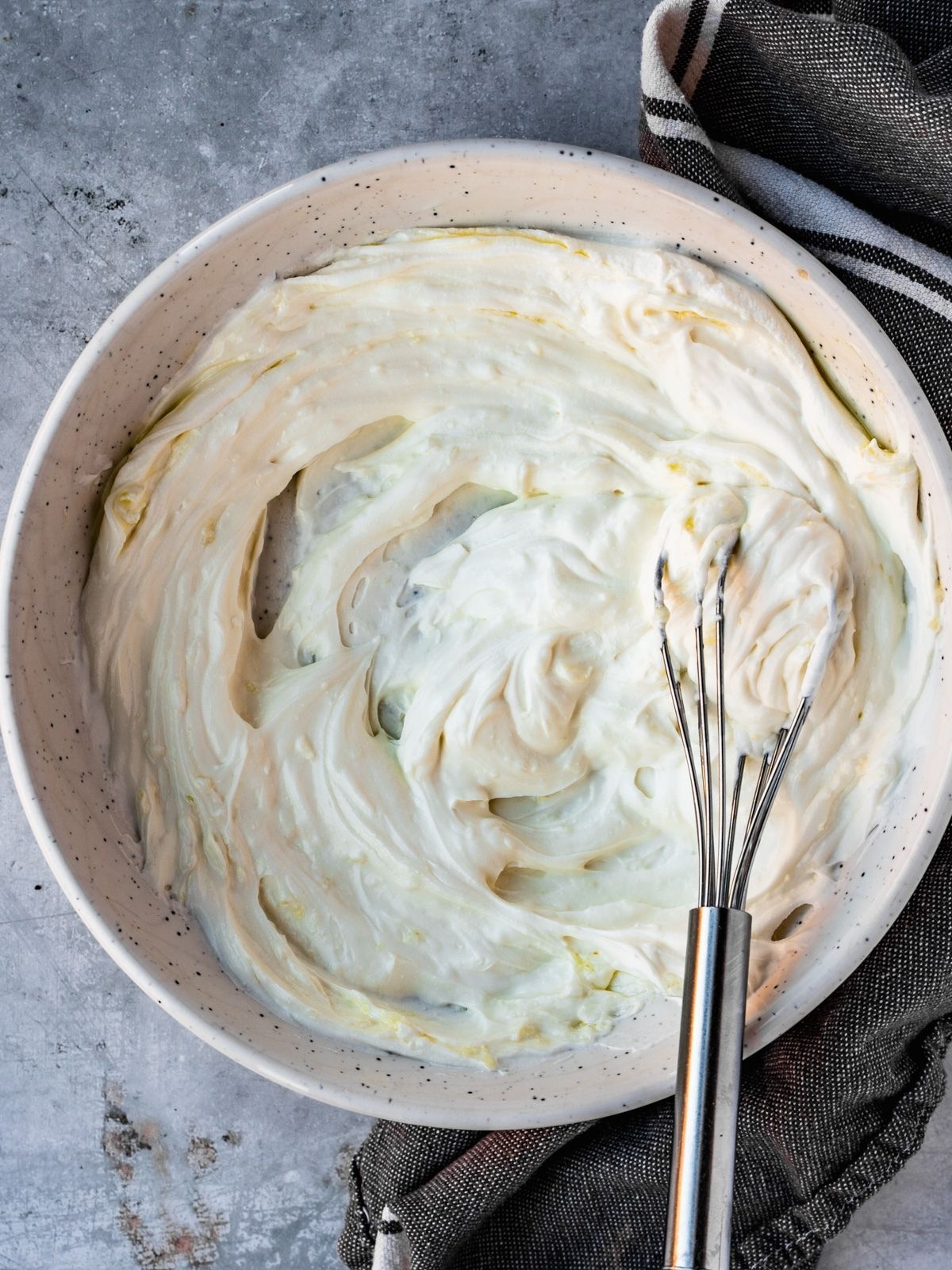 Bowl with labneh, garlic and olive oil whisked together.
