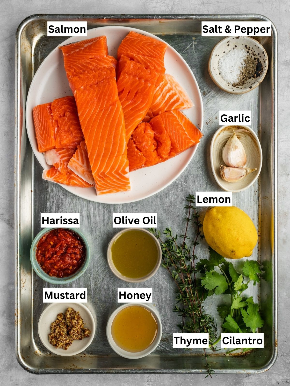 Honey Harissa Salmon Recipe ingredients with individual labels on a metal tray.
