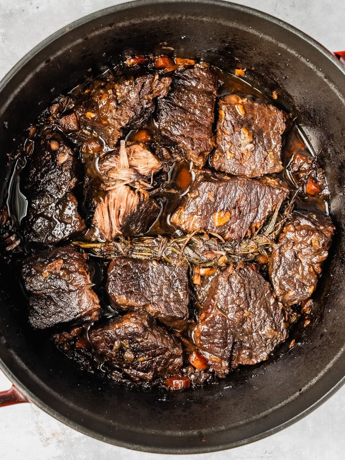 Fall apart tender Beef short ribs in a pot after getting braised for 3 hours.