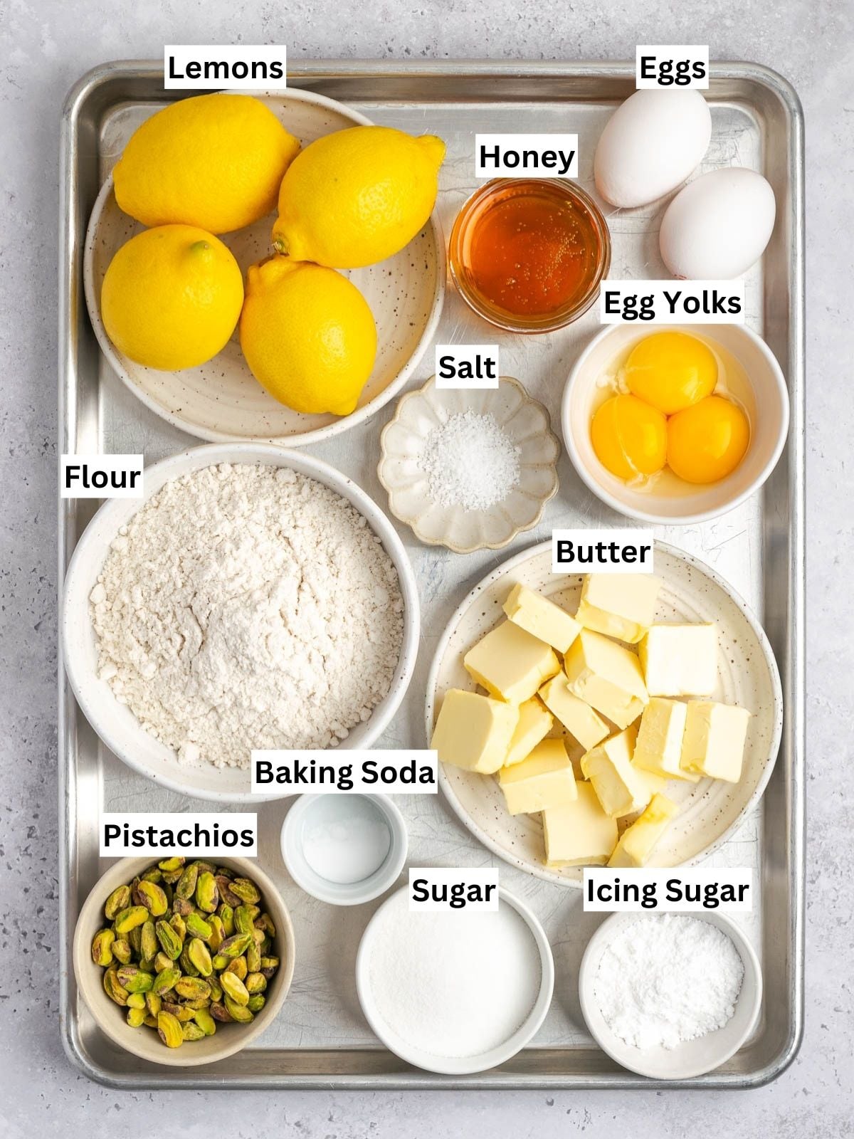 Pistachio Lemon Bars recipe ingredients with individual labels on a metal tray.