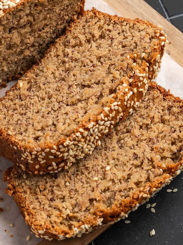 Sliced tahini banana bread on parchment paper.