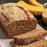 Sliced tahini banana bread on parchment paper.
