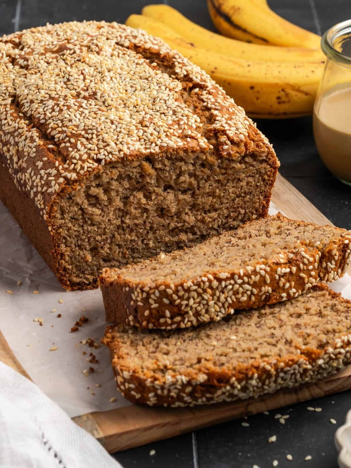 Sliced tahini banana bread on parchment paper.