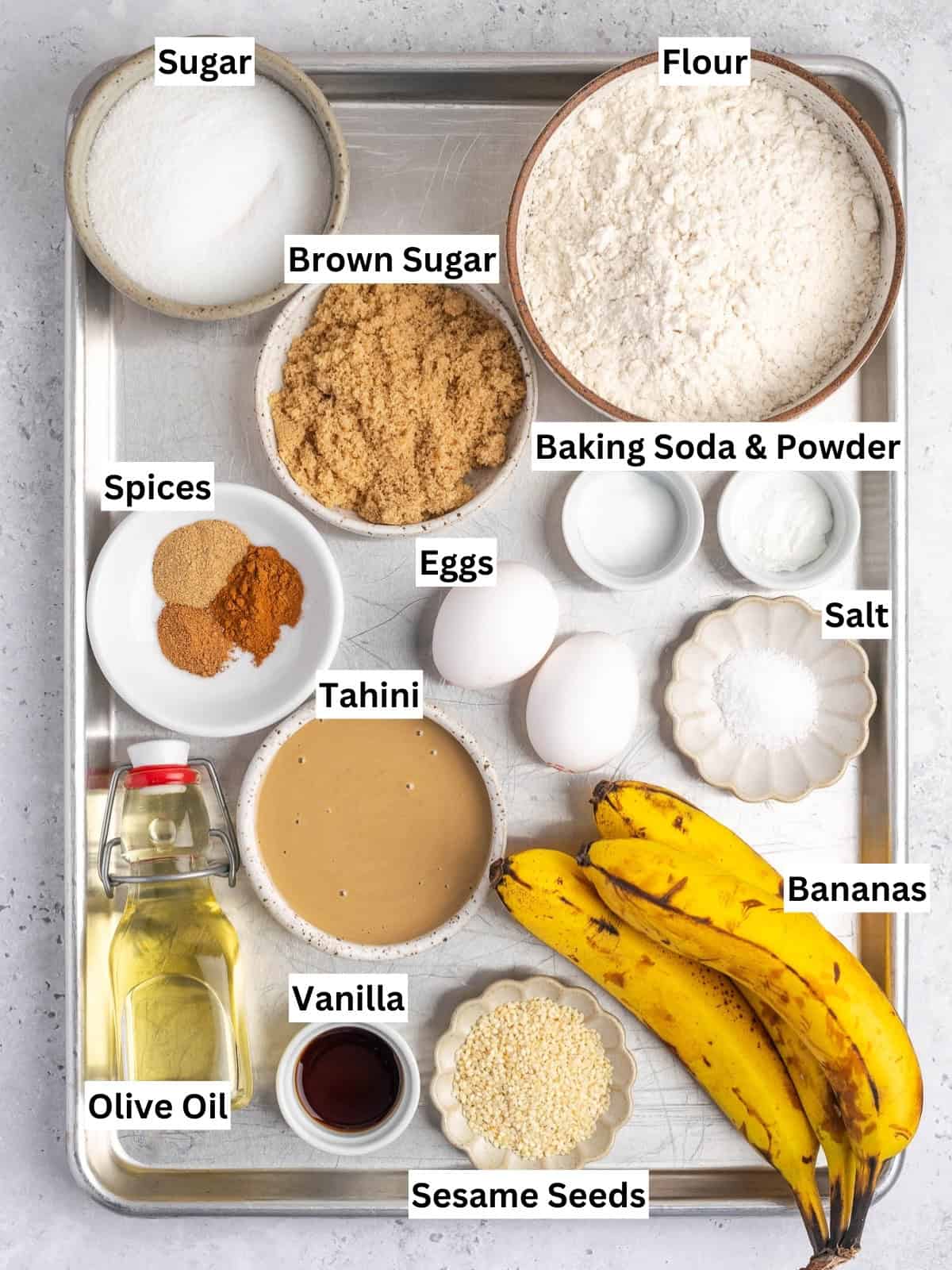 Tahini Banana Bread recipe ingredients with individual labels on a metal tray.