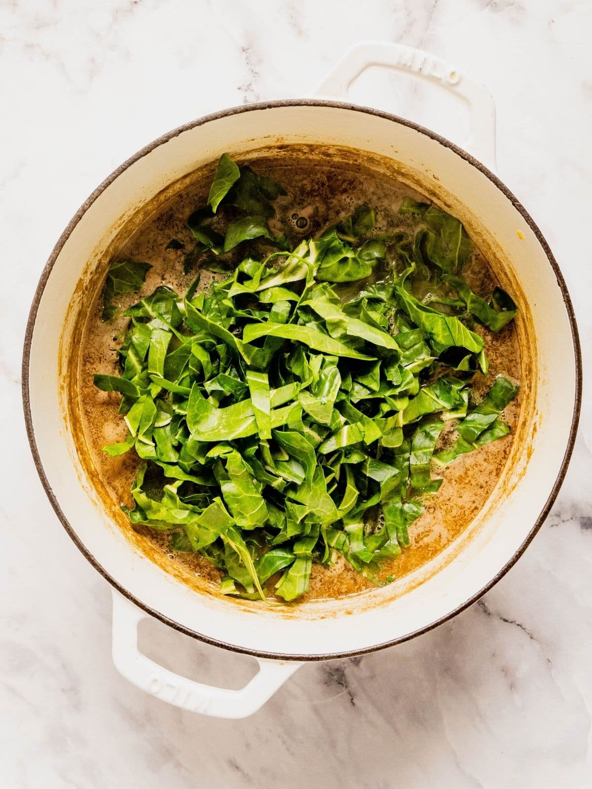 Recipe step showing the addition of the chopped chard to the lentil soup.