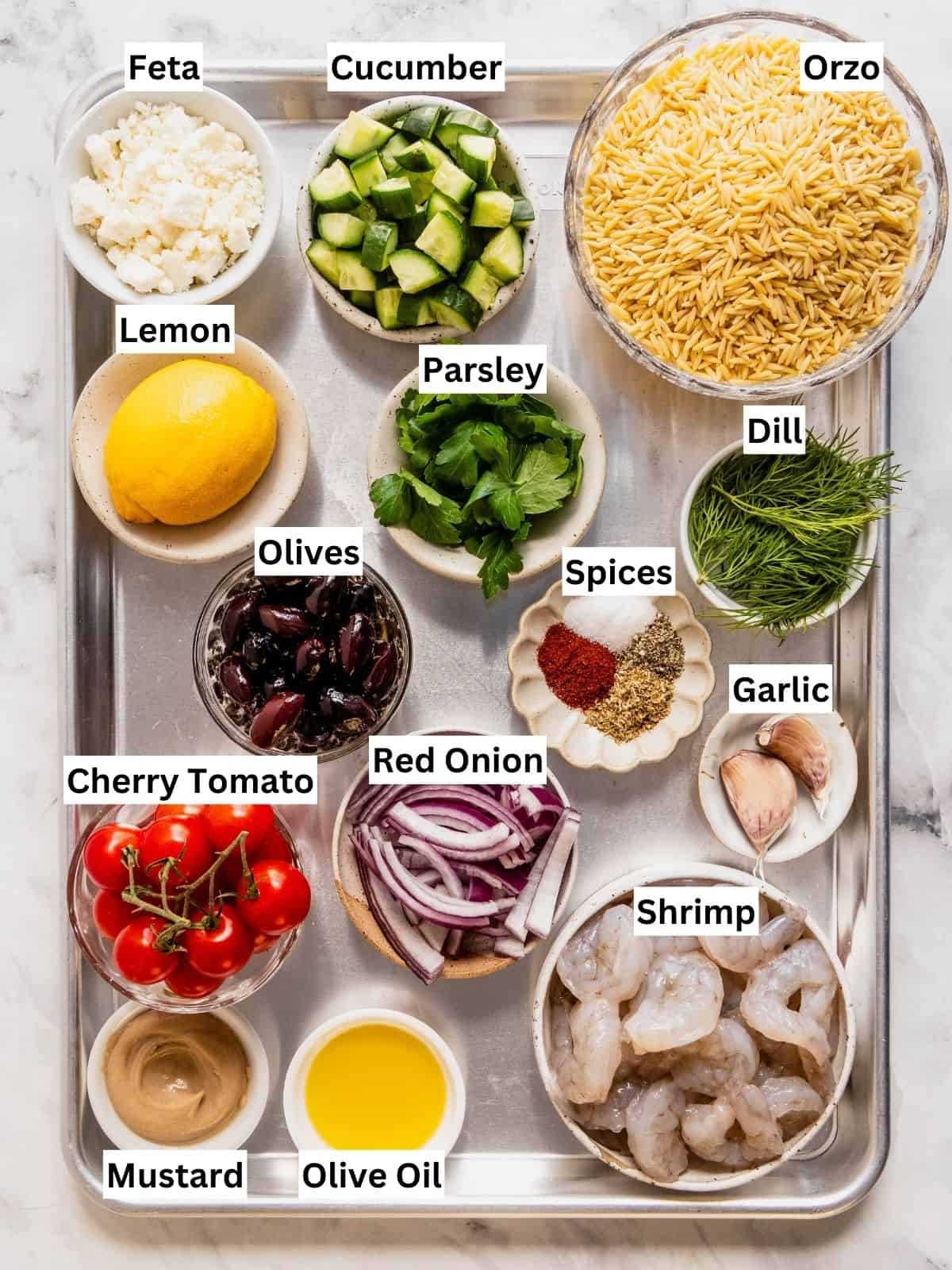 Mediterranean orzo salad with shrimp recipe ingredients with individual labels on a metal tray.