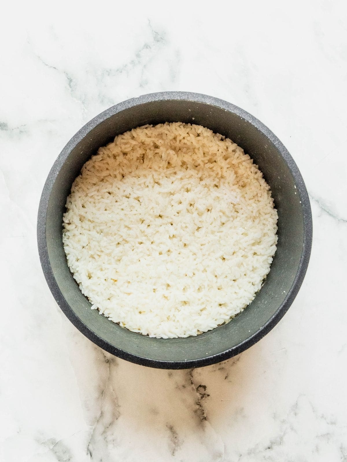Cooked rice in a rice cooker pot.