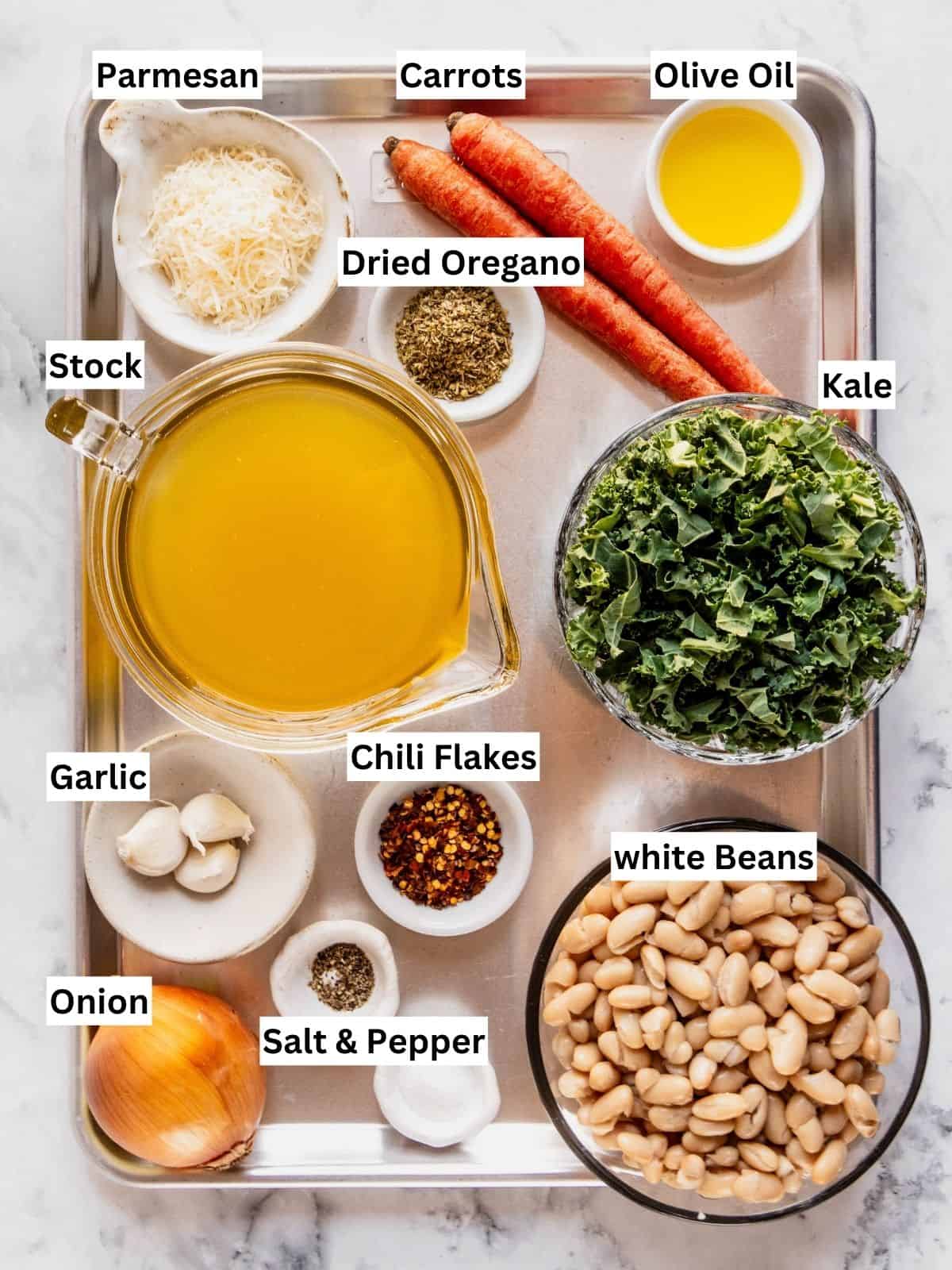 Tuscan white bean soup with kale recipe ingredients with individual labels on a metal tray.