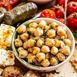 A mezze board with stuffed grape leaves, meatballs and marinated chickpeas.