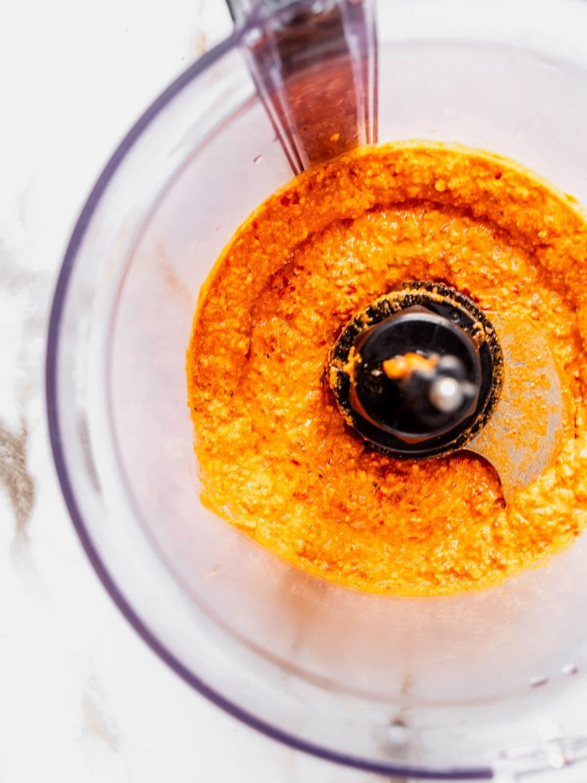 Food processor showing the final smooth consistency of the dip.