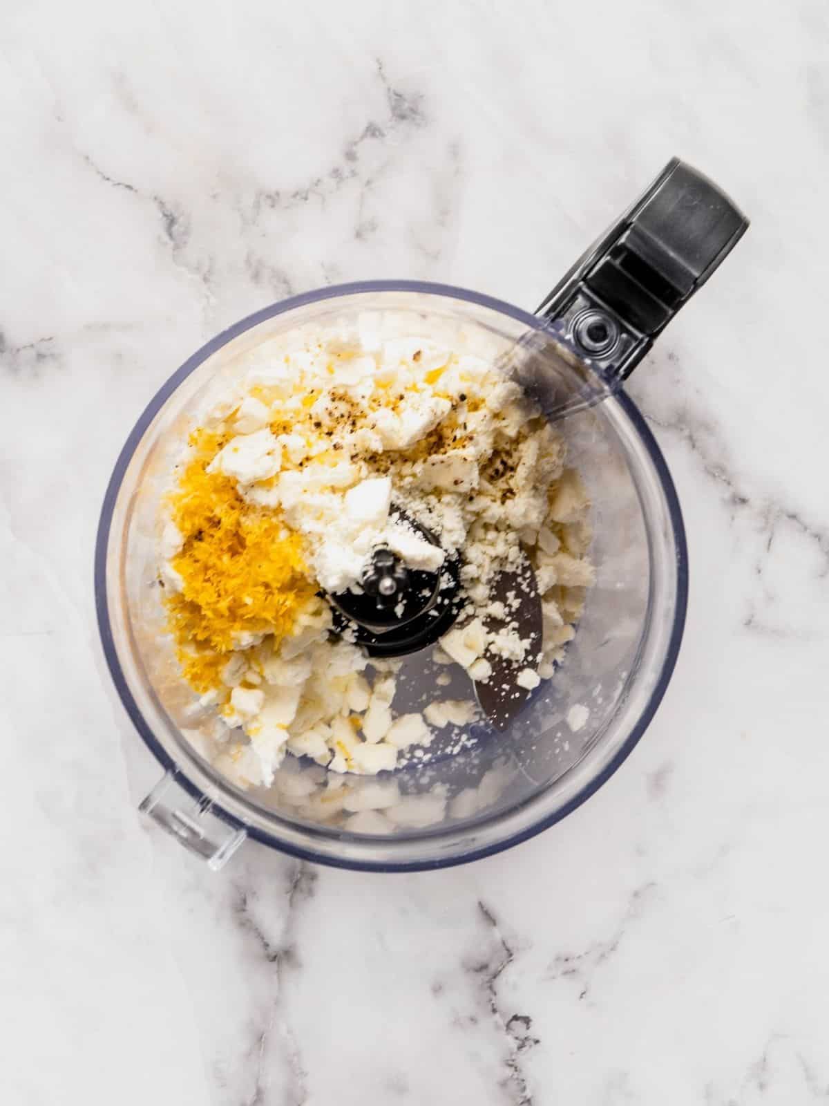 Feta, yogurt, lemon zest, olive oil and garlic in a small food processor.