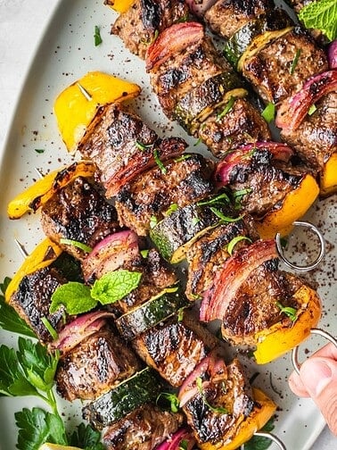 Platter with skewered and grilled middle eastern style beef cubes.
