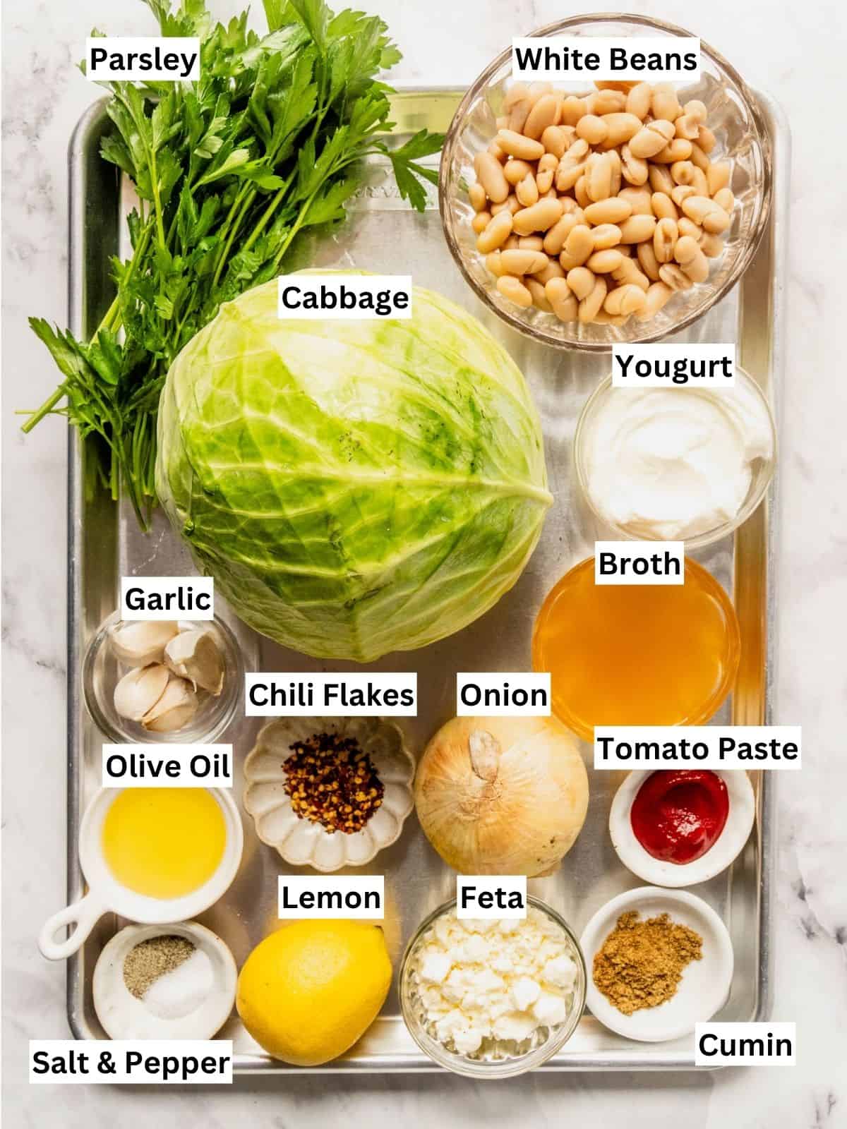 Braised cabbage with white beans recipe ingredients with individual labels on a metal tray.