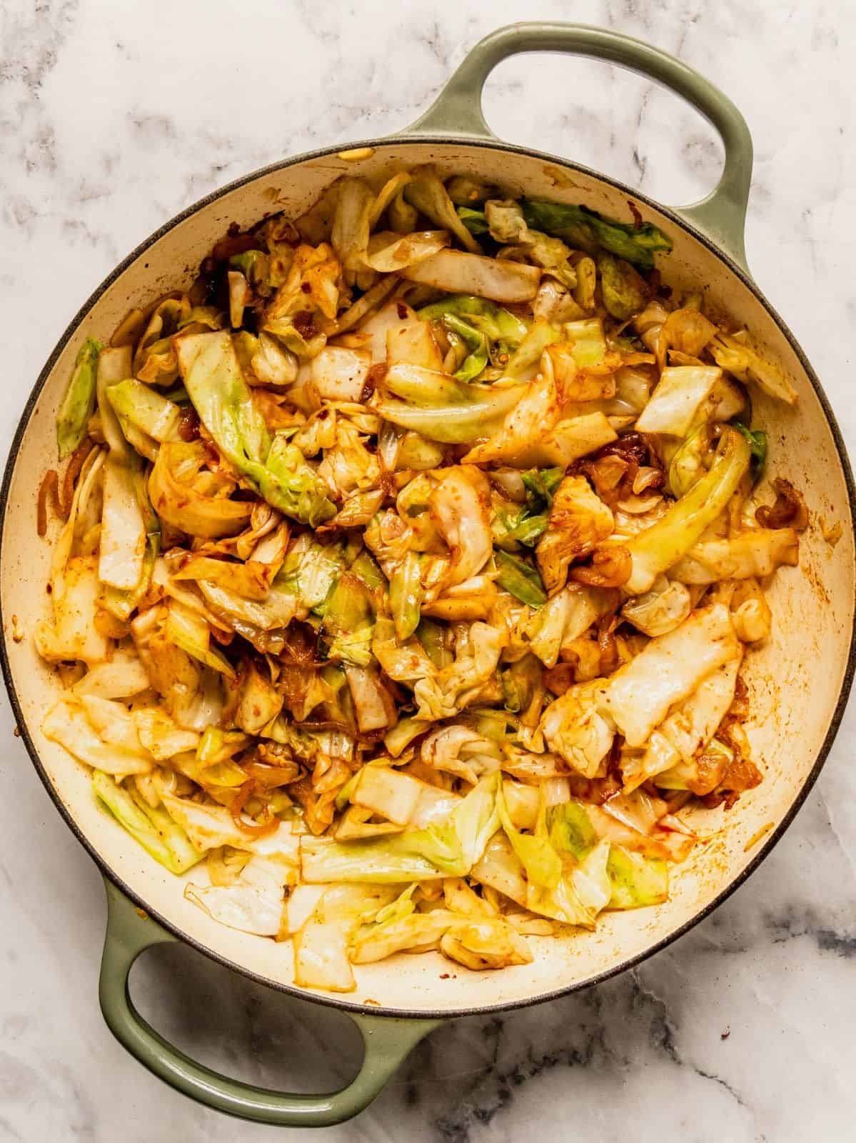 Pot with softened sauteed cabbage and spices.