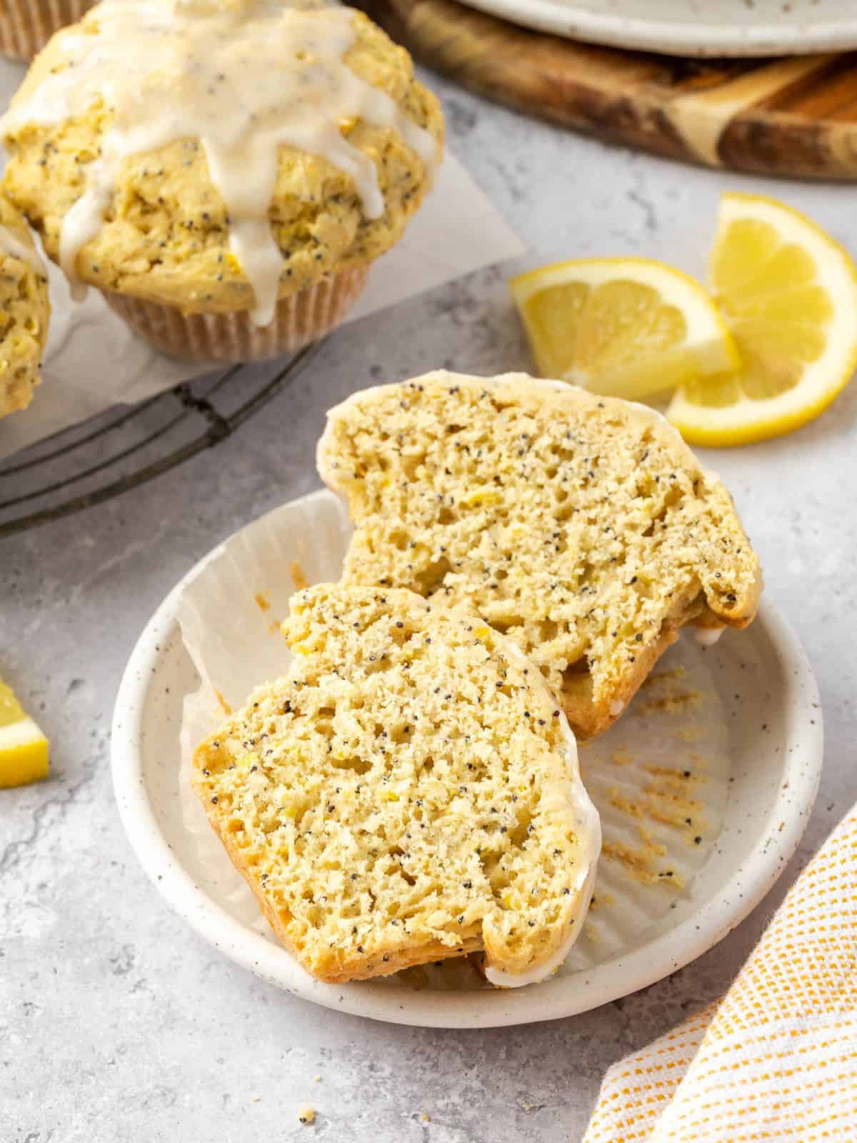 Cross-section of lemon poppyseed muffins on a plate.