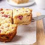 Sliced rhubarb custard bars on a wooden board.