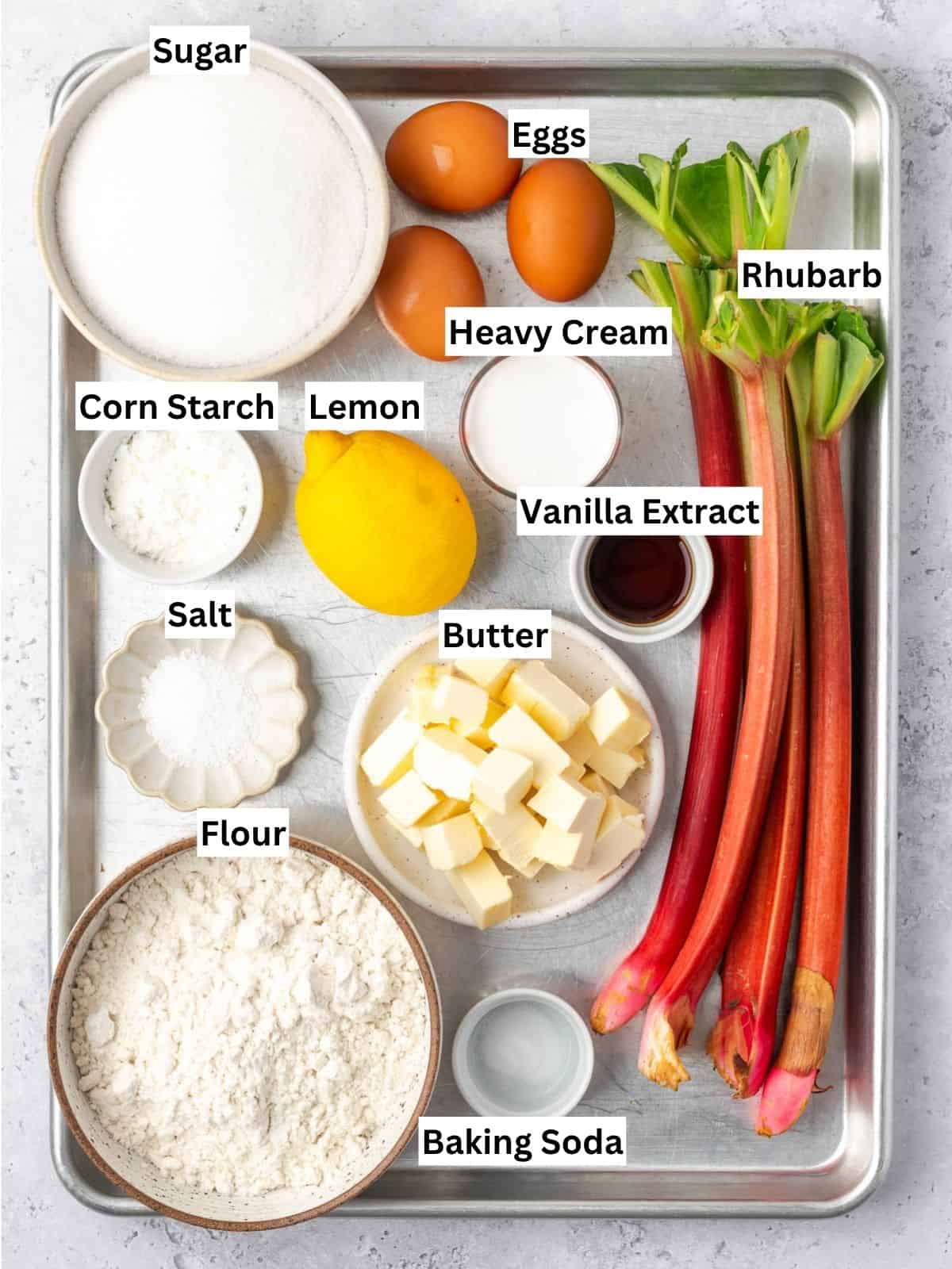 Rhubarb custard bars recipe ingredients with individual labels on a metal tray.