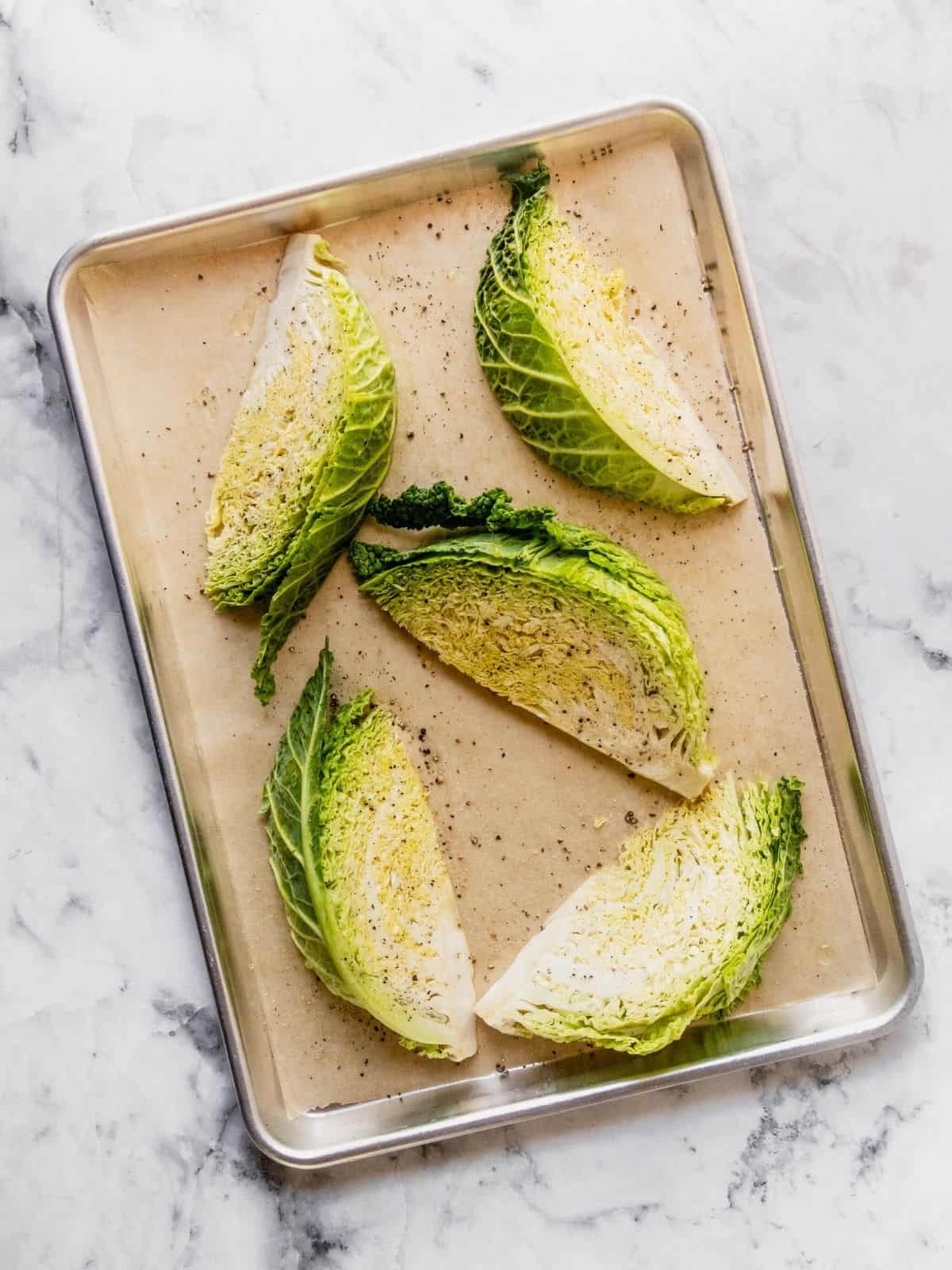 Romaine lettuce wedges on a baking sheet, perfect for salads or grilling.