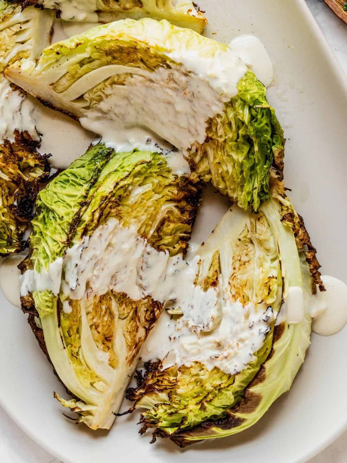 Tahini sauce drizzled over the roasted cabbage.