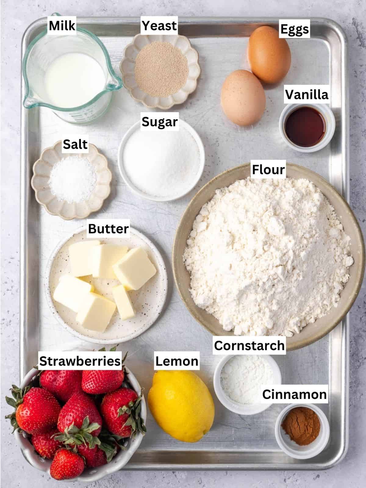 Strawberry Cinnamon Rolls recipe ingredients with individual labels on a metal tray.