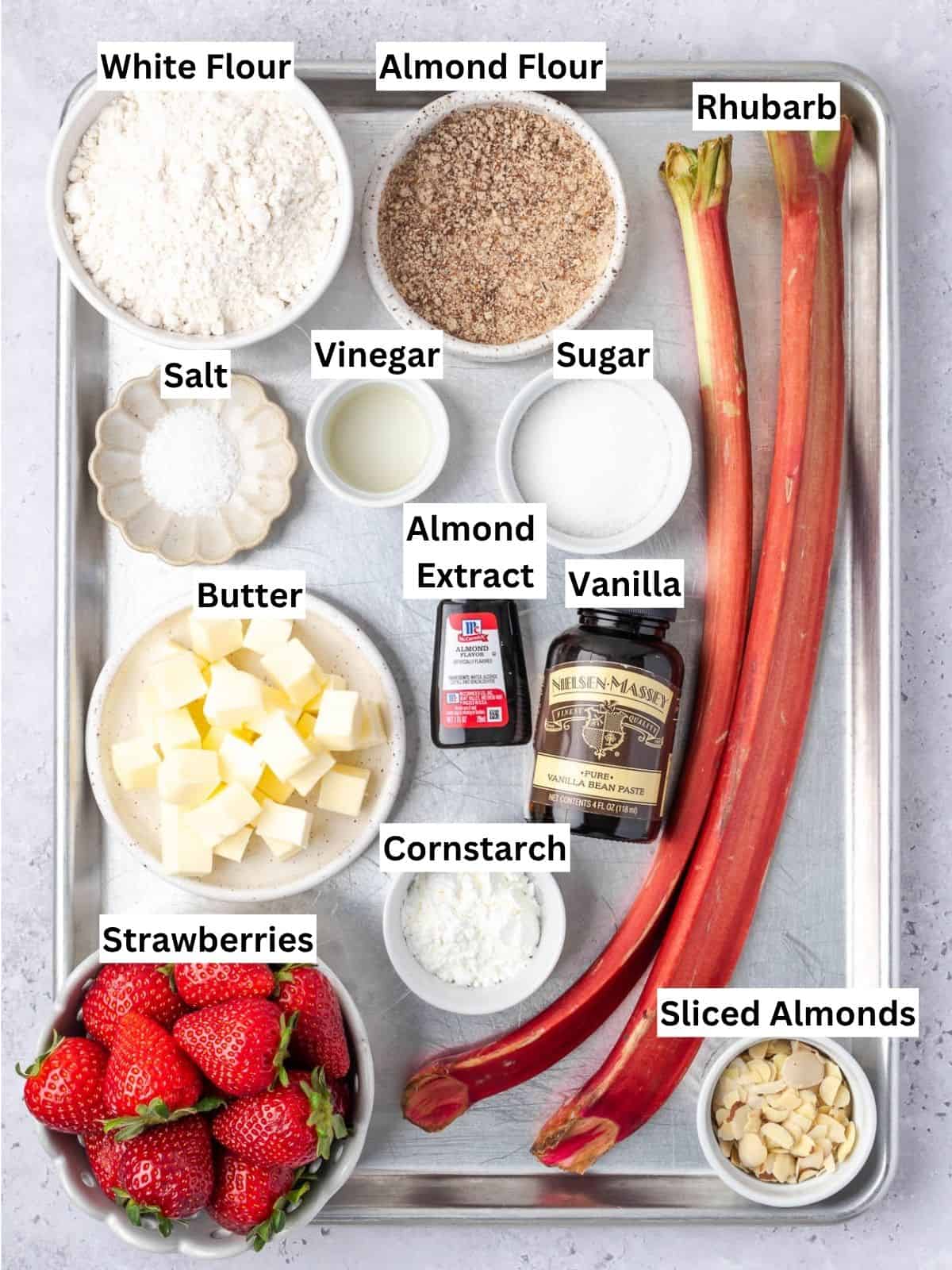 Strawberry Rhubarb Galette recipe ingredients with individual labels on a metal tray.