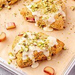 Rhubarb Scones with Orange and Pistachios on parchment paper lined baking sheet.