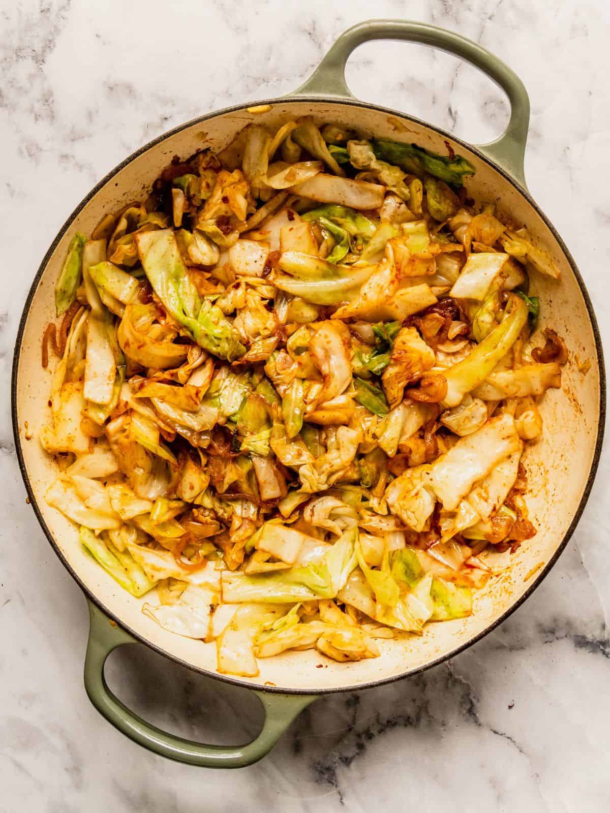 Pot with softened sauteed cabbage and spices.