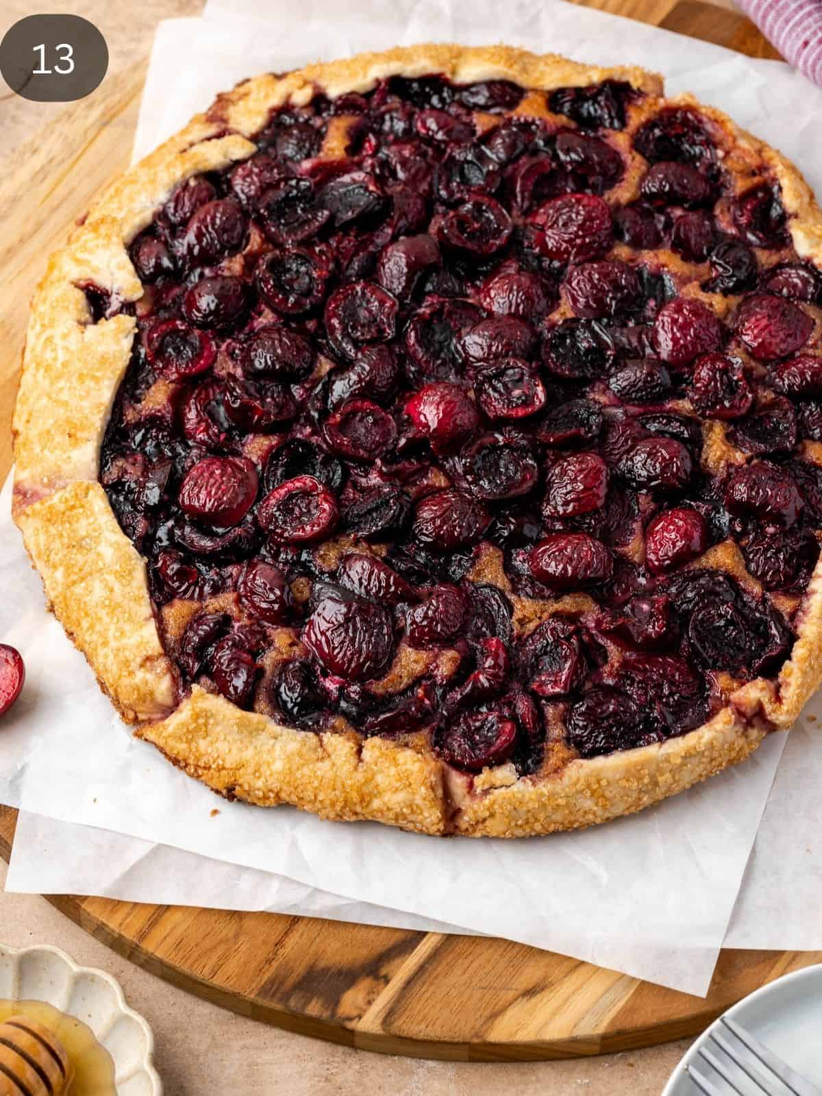 Baked Cherry galette with walnut frangipane on parchment paper.