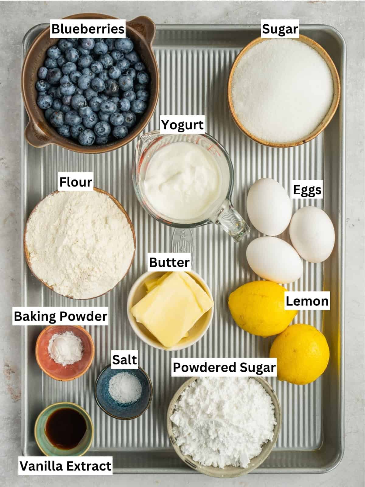 Lemon blueberry loaf recipe ingredients with individual labels on a metal tray.